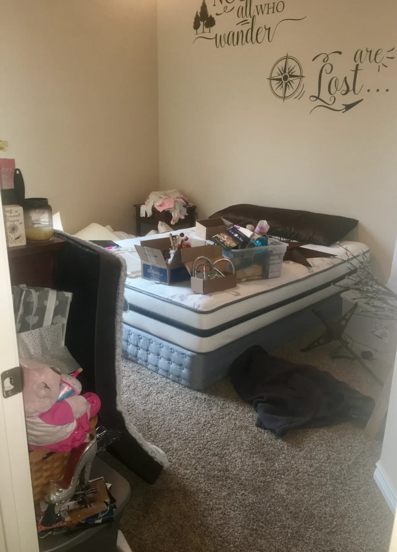Before picture of a messy guest bedroom used for storage